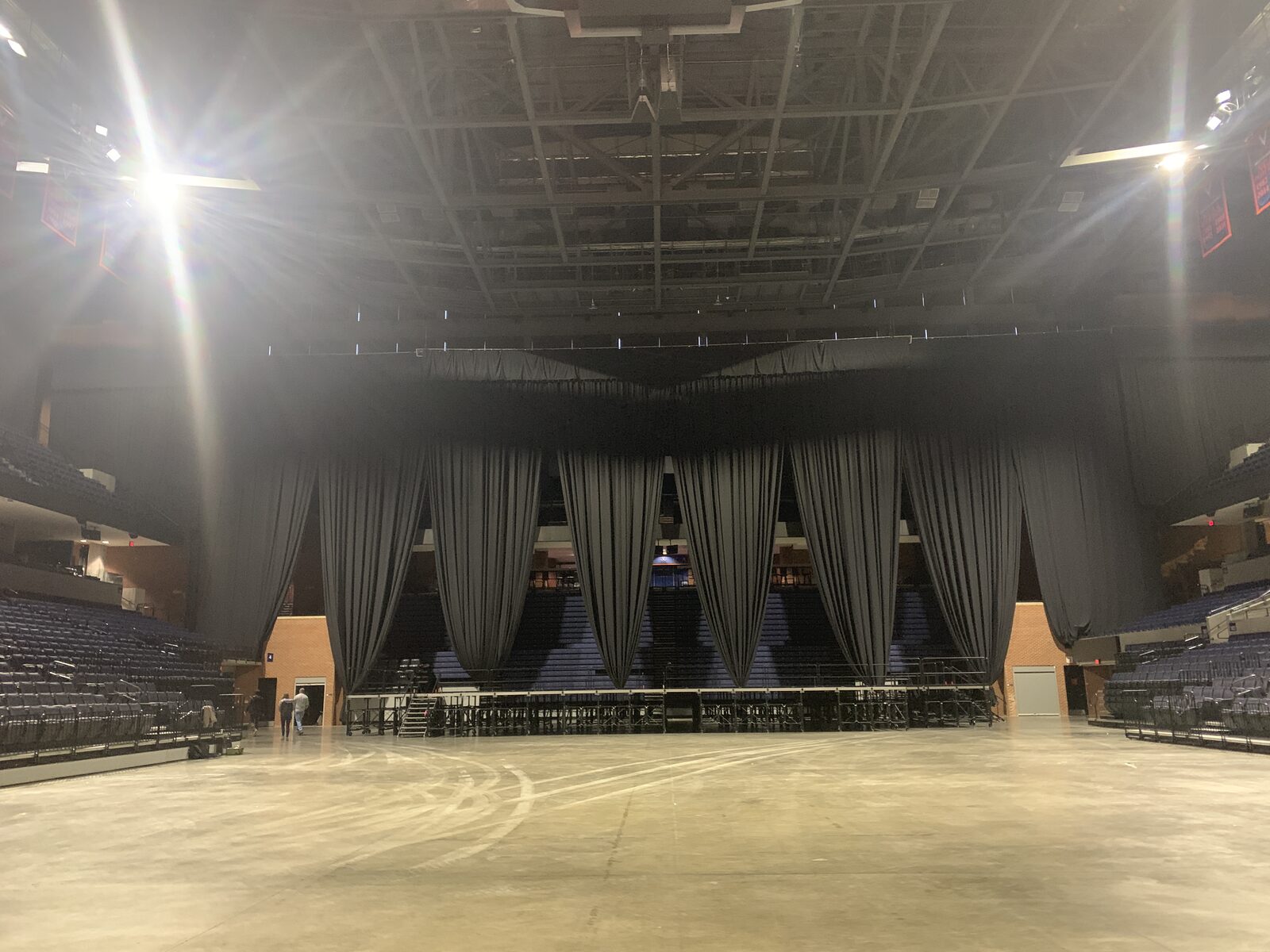 Massive black drape installation with gathered swoops in arena venue