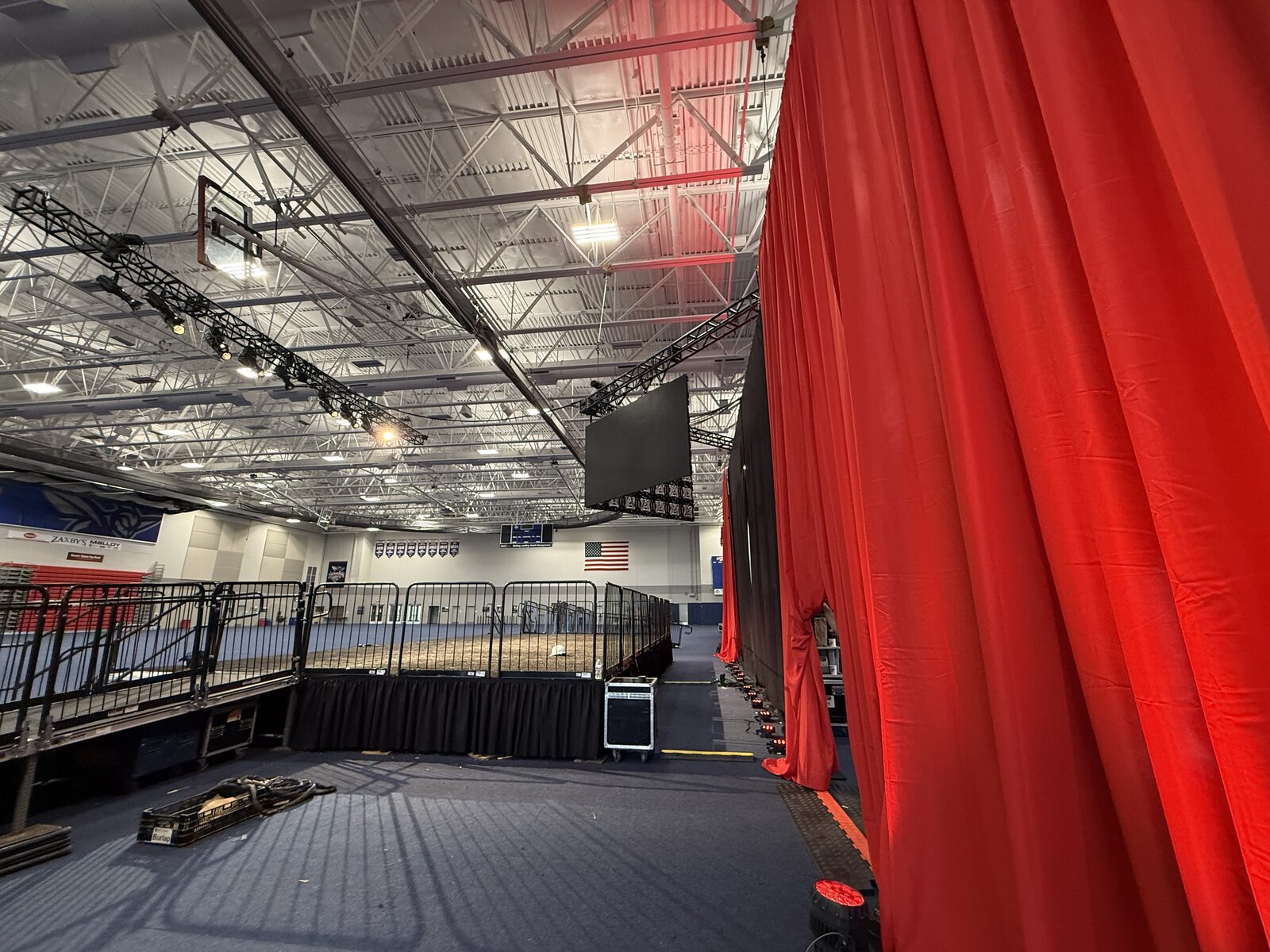 Red drape wall in arena during event setup